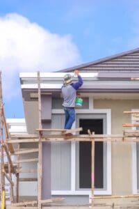 painting roof eaves of modern house structure
