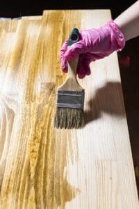 Professional wood staining process on pressure-treated wood surface by Miles Pro Painting