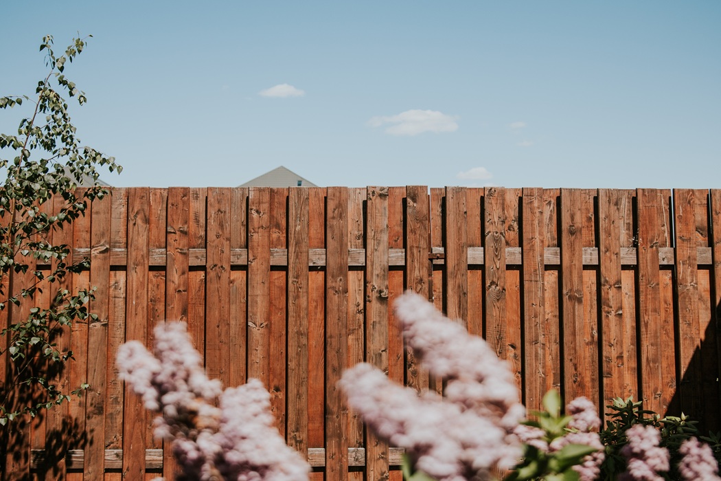 wooden Stain fence enhancing curb appeal and long-lasting protection for a New Hampshire home