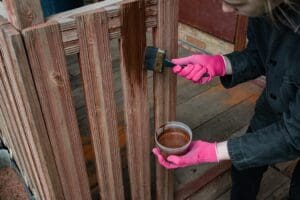 Well-maintained wooden fence with a professional stain finish designed to protect against New Hampshire weather.